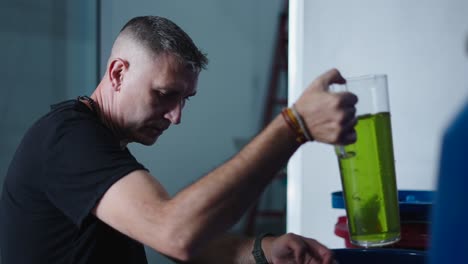 researcher working with a green liquid in a laboratory