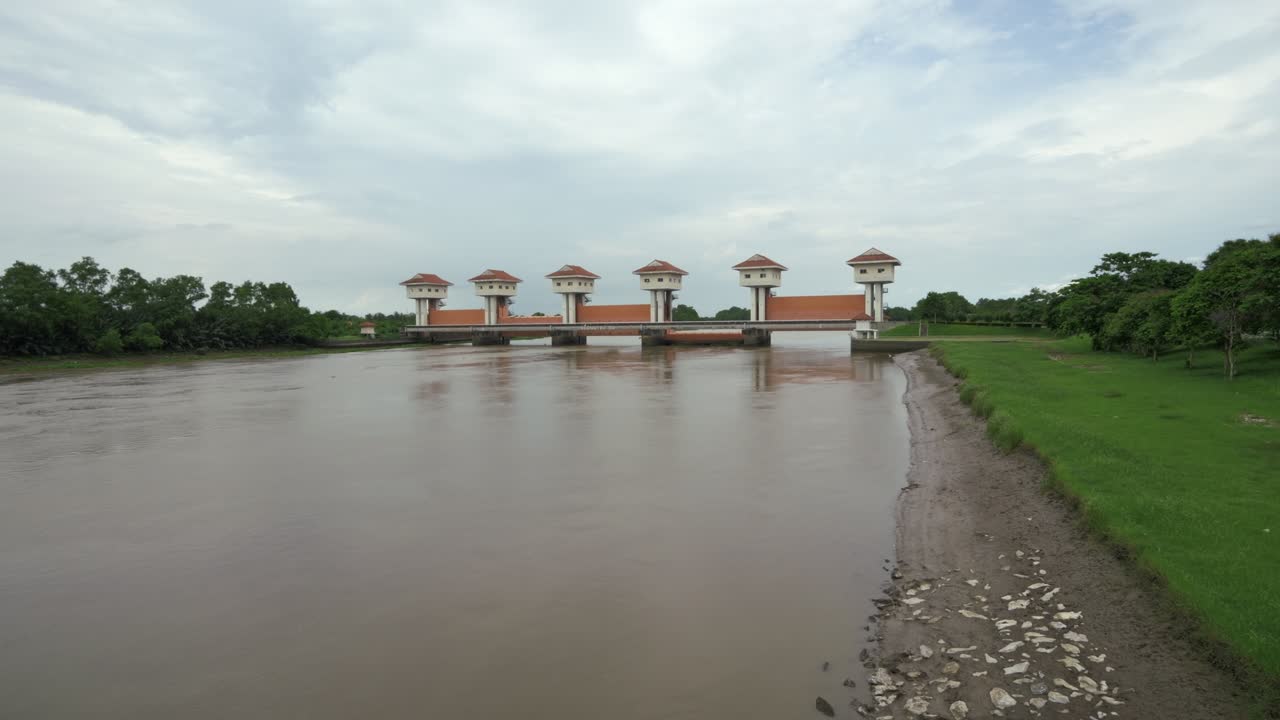 Exploring the significance of flood control gates managing river waters a serene rural landscape