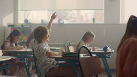 students sitting at desks in school class. kids having lesson in classroom