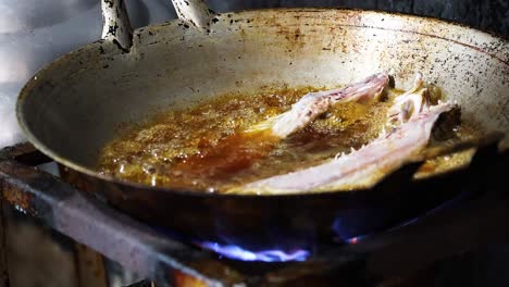 sequence of frying fish in hot oil on stove