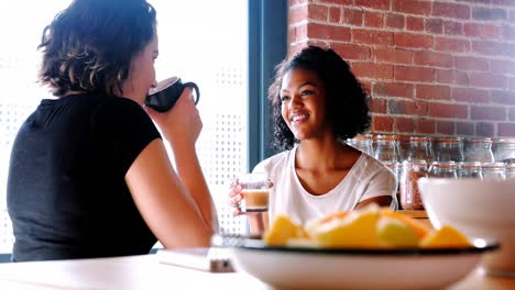 Lesbian-couple-interacting-with-each-other-while-having-breakfast