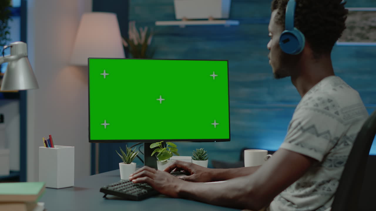 African american man working with horizontal green screen