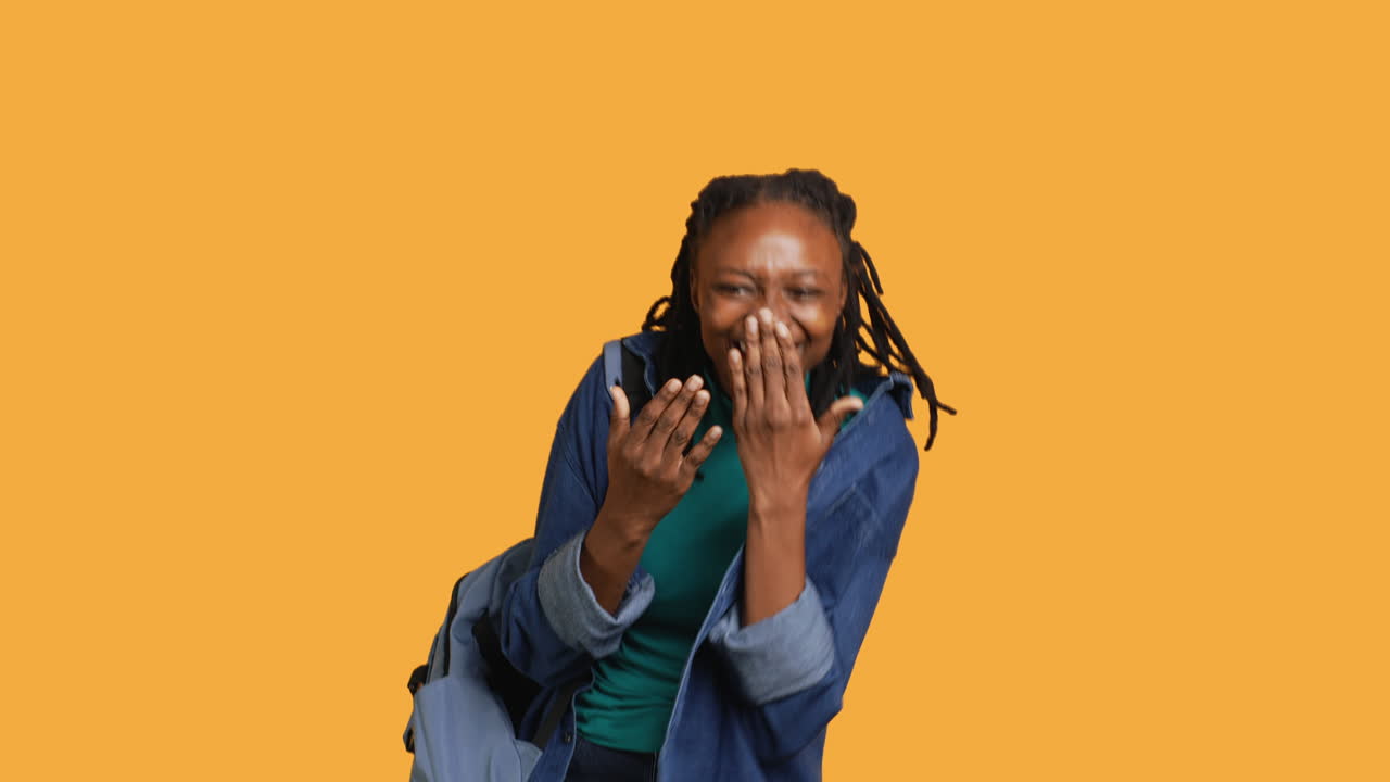 Upbeat teenager goofing around, acting silly, studio background