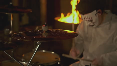 drummer with mask performing on drums