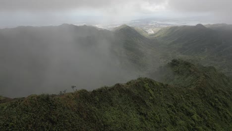 Fog-rises-up-Moanalua-Valley,-Pearl-Harbor-in-Honolulu-seen-far-below