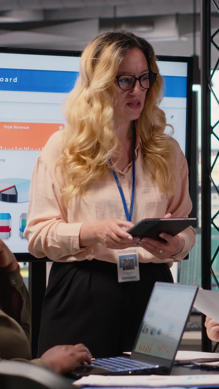 Vertical Video General director hosting a briefing session with her team to present data