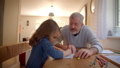 Grandfather-And-Granddaughter-Colouring-Picture-Together