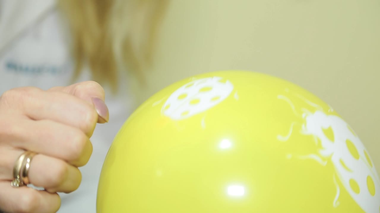 Child checks eyesight in ophthalmological center. Yellow ball closeup.