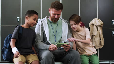 Man-and-children-at-the-locker-room