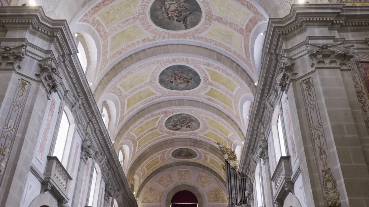 Intricate painted ceiling arches in Bom Jesus Church, Braga, Portugal, with soft lighting