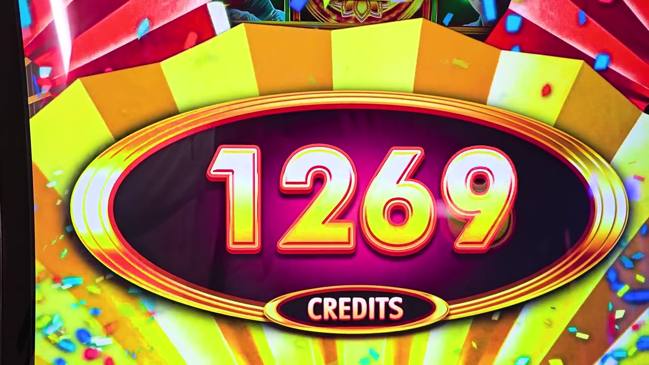 Detailed casino slot display showing jackpot style win graphics, glowing gold numbers, neon reflections, colorful confetti, and prize credits for gaming entertainment videos.