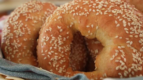 close up of fresh bagels with sesame seeds, slide right