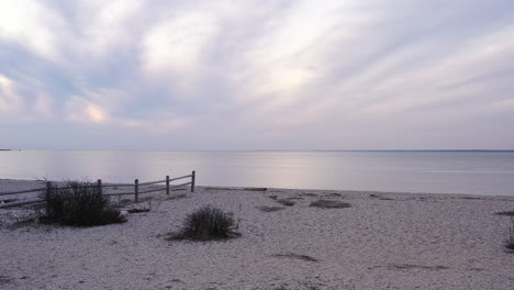 a low angle view of the long island sound by orient point on long island, new york during a golden sunset with cloudy skies