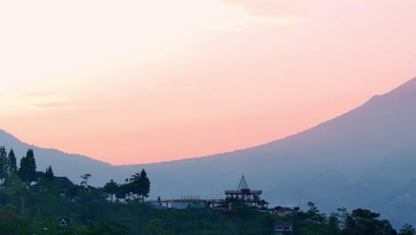 aerial view of countryside building on the hill with sunrise sky on the background