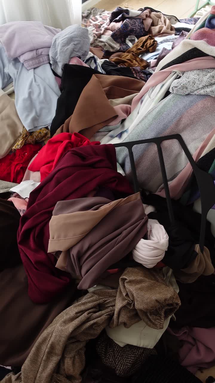 Large Pile of Messy Clothes and Fabrics on the Floor