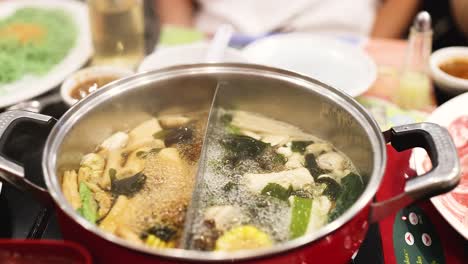 simmering hotpot with vegetables and broth