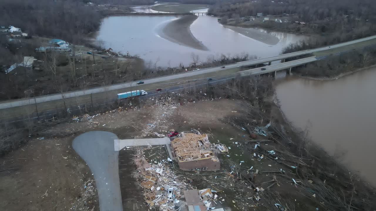 Aerial zoom video of a destroyed home after a tornado on Lake Barkley, Kentucky. 2021-12-10.  Dramatic debris trail visible by highway