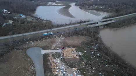 aerial zoom video of a destroyed home after a tornado on lake barkley, kentucky. 2021-12-10.  dramatic debris trail visible by highway