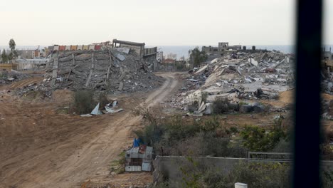 destroyed buildings in gaza, view through the window, establishing war footage