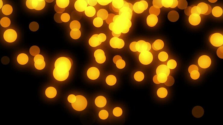 Luci Bokeh Gialle Astratte e Luminose in Movimento su Sfondo Nero