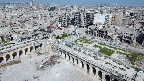 aerial view over ruined muslim mosque in aleppo, under blue sky. buildings of the city of aleppo are ruined after civil war in syria.