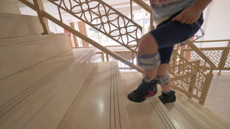 kid with foot drop system walking upstairs