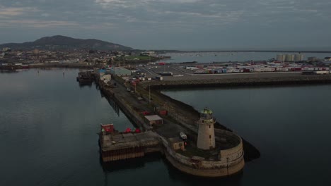 holyhead admiralty pier lighthouse aerial view circling salt island waterfront at sunrise