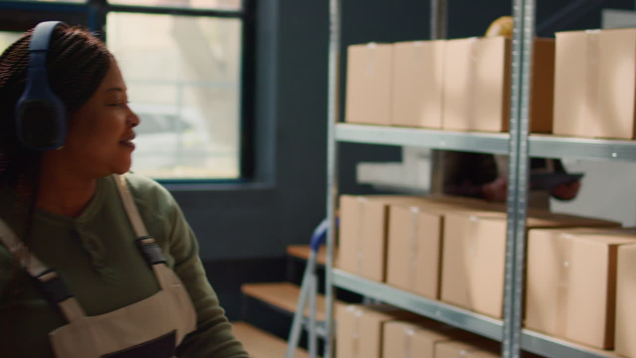 People working in warehouse with boxes on shelves
