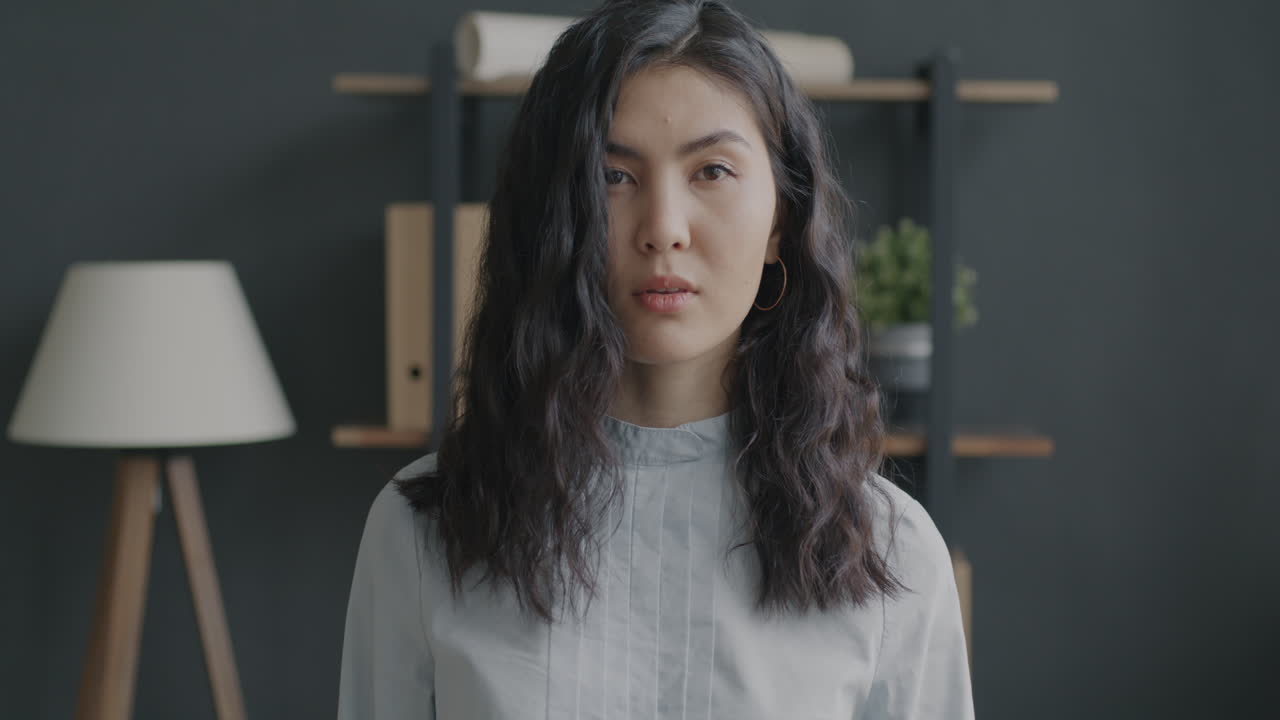 Confident Asian Woman in Office Setting