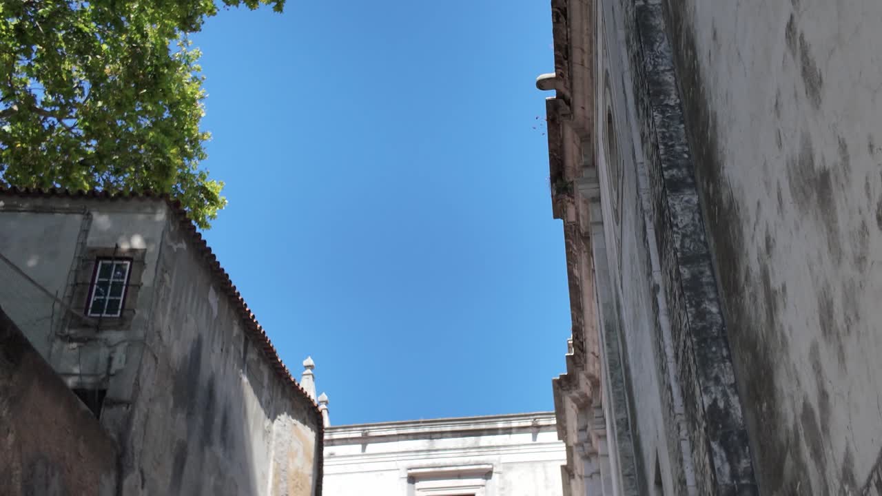 Arco Grande de Cima with its particular architecture connecting two buildings in Lisbon, Portugal. Tilt Down