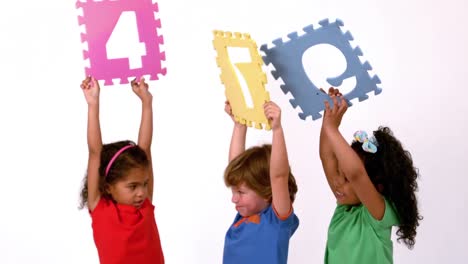 school kids holding up coloured signs