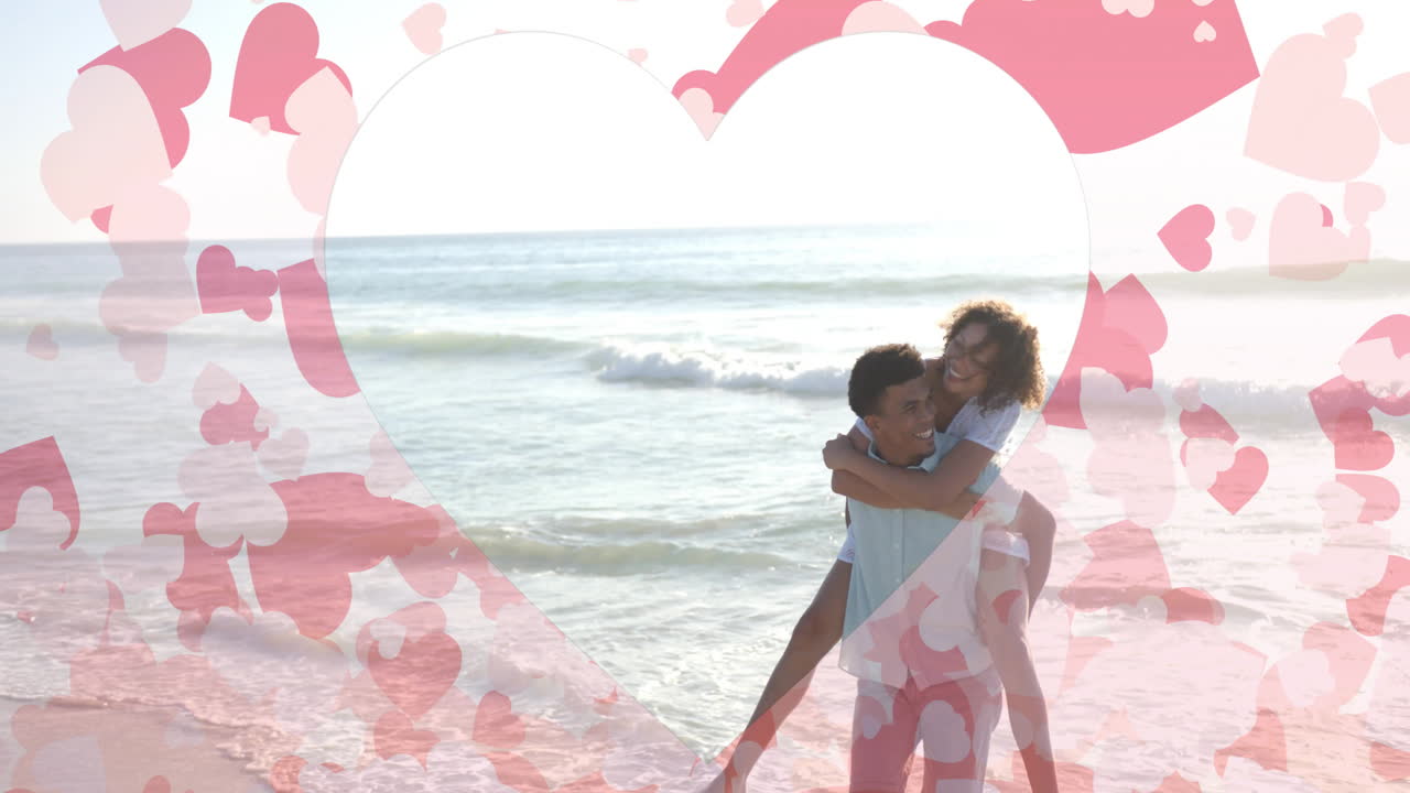 여름에 해변에서 피기백을 들고 있는 두 인종의 남자를 가로질러 움직이는 마음의 애니메이션