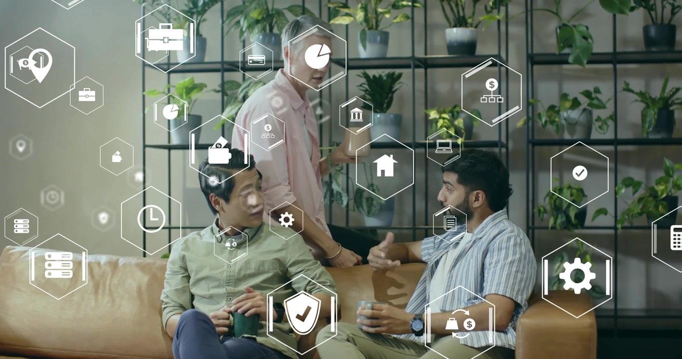Woman leaning over couch showing tablet to team, sparking floating icons illustrating business data