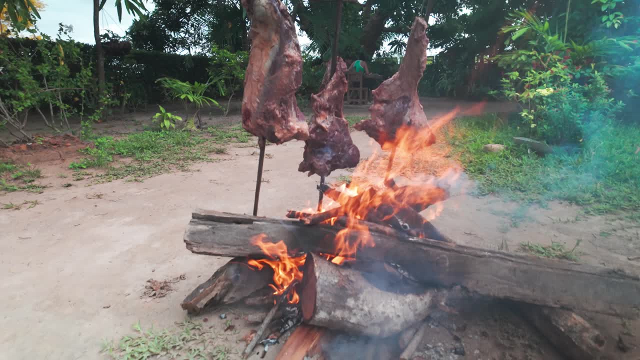 Cooking meat on sticks in traditional Venezuelan style in Los Llanos region