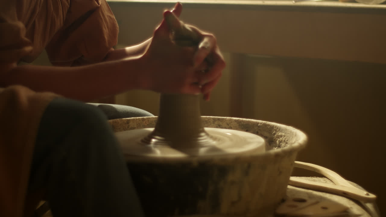 Pottery Artist Shaping Clay on Wheel