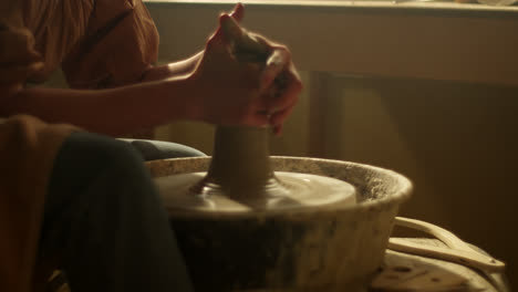 pottery artist shaping clay on wheel