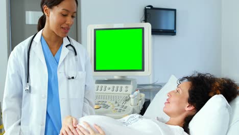 doctor interacting with pregnant woman