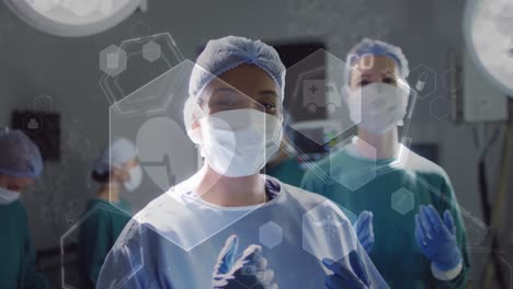 Animation-of-medical-icons-and-data-over-diverse-female-surgeons-in-operating-theatre