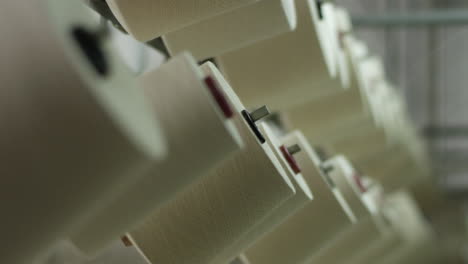 layers of cotton bobbins and unwinding threads in textile winding machinery in a textile factory in china