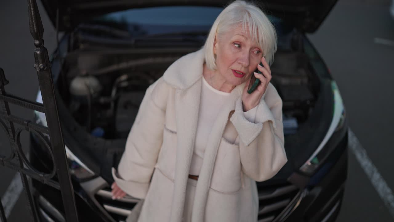 Elderly woman on phone with car trouble