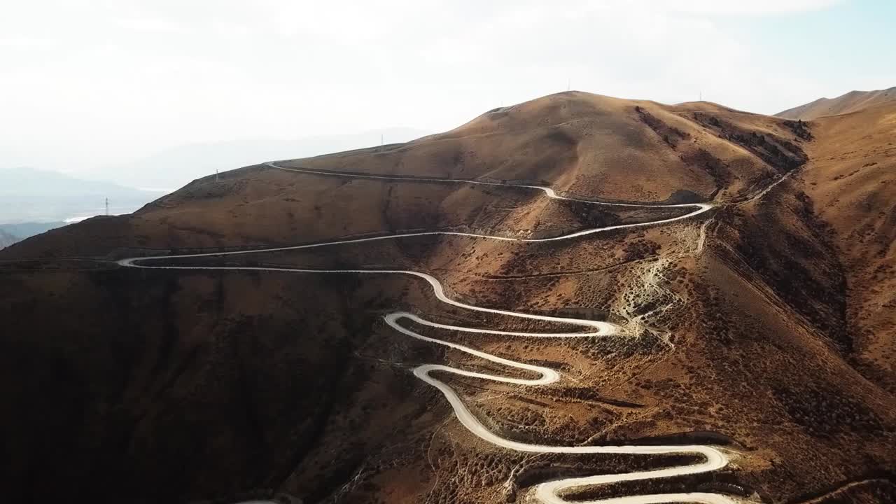 cortando la carretera a través de un paso de montaña a 3000m en kirguistán