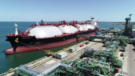 massive gas tanker docked at industrial facility, showcasing advanced infrastructure and maritime operations in a coastal setting