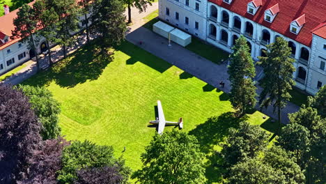 aerial view of plane landed in yard of biržai castle in lithuania on summer day