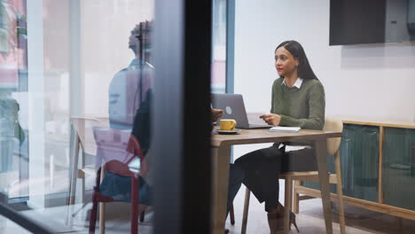 businesswoman interviewing male job candidate in meeting room