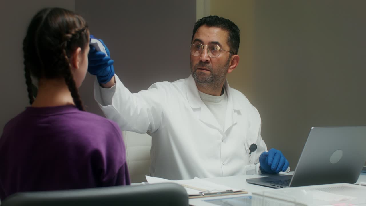 Doctor examining a child's temperature