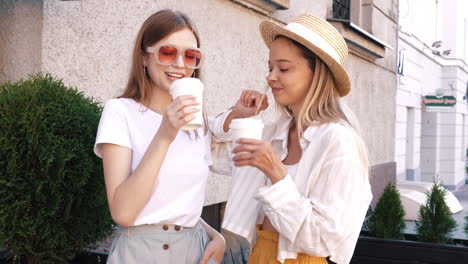 two women friends enjoying coffee outdoors