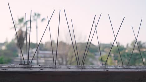 Bird-Control-Spikes-Attached-to-Window-Ledge,-Close-Up-Slider-Right