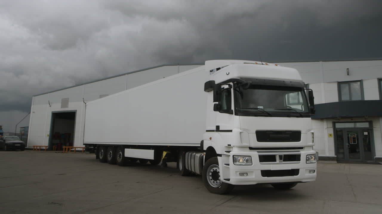 A white truck parked in a loading area