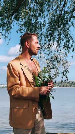 man with flowers by the lake