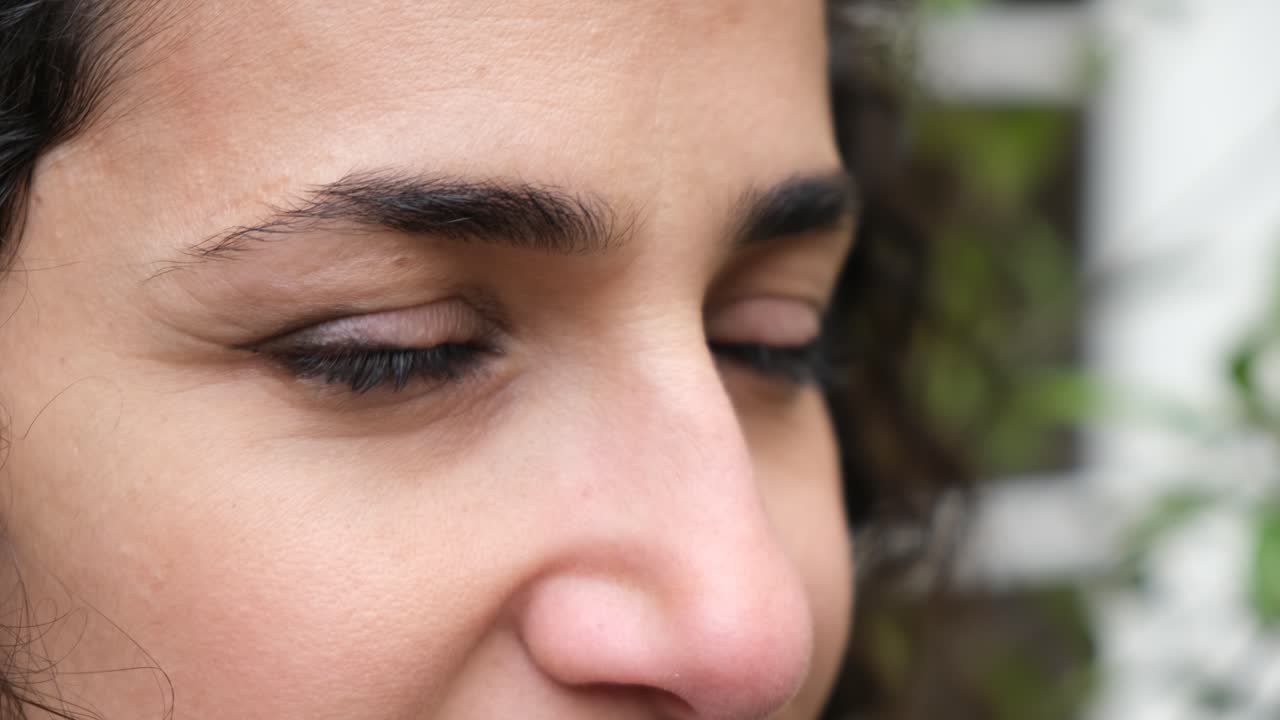 close up of woman's eyes slowly tearing up